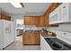 Modern kitchen featuring wood cabinets, white appliances, and a breakfast bar at 1429 Yates St, Orlando, FL 32804