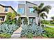 Modern two-story home with gray exterior, landscaping, and palm trees at 14519 Crested Plume Dr, Winter Garden, FL 34787