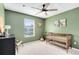 Charming Bedroom with crib and calming green walls at 14531 Clarkson Dr, Orlando, FL 32828