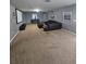 Finished basement with a large sectional sofa and projector at 1662 Lima Ave, Kissimmee, FL 34747