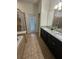 Elegant bathroom with double vanity, soaking tub, and walk-in shower at 1662 Lima Ave, Kissimmee, FL 34747