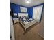 Bright bedroom with king-size bed and blue walls at 1662 Lima Ave, Kissimmee, FL 34747