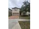 Two-story house with a brown brick driveway and palm trees at 1662 Lima Ave, Kissimmee, FL 34747