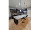 Modern kitchen with dark cabinets, granite counters, and island at 1662 Lima Ave, Kissimmee, FL 34747