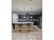 Modern kitchen with dark cabinets, granite counters, and island at 1662 Lima Ave, Kissimmee, FL 34747