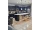 Modern kitchen with dark cabinets, granite counters, and island at 1662 Lima Ave, Kissimmee, FL 34747