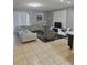 Spacious living room with gray sectional sofa and large TV at 1662 Lima Ave, Kissimmee, FL 34747