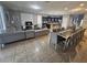 Open living space with sectional sofa and large dining table at 1662 Lima Ave, Kissimmee, FL 34747