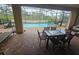 Patio with pool, table, chairs and lounge chairs at 1662 Lima Ave, Kissimmee, FL 34747