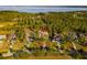 Aerial view of the luxury home in a wooded neighborhood and scenic lake in the distance at 16902 Vinci Way, Montverde, FL 34756
