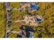Aerial view of three luxury homes with private pools, mature landscaping, and ample parking at 16902 Vinci Way, Montverde, FL 34756