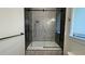 Modern bathroom featuring a stylish shower-tub combo with a glass screen and patterned tile accents at 16902 Vinci Way, Montverde, FL 34756