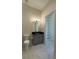 Bright bathroom features a sleek vanity with modern fixtures and a spacious, organized linen closet at 16902 Vinci Way, Montverde, FL 34756