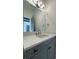 Bathroom featuring a gray vanity with a white countertop, modern mirror, and bronze hardware at 16902 Vinci Way, Montverde, FL 34756
