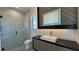 Contemporary bathroom featuring a glass-enclosed shower, unique mirror, modern vanity, and hexagonal tile flooring at 16902 Vinci Way, Montverde, FL 34756