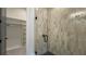 Modern bathroom features a tiled shower with glass door, complemented by an adjacent walk-in closet at 16902 Vinci Way, Montverde, FL 34756