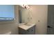 Bathroom featuring a gray vanity with a white countertop, modern mirror, and window at 16902 Vinci Way, Montverde, FL 34756