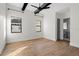 Minimalist bedroom with hardwood floors, ample natural light, and a modern ceiling fan at 16902 Vinci Way, Montverde, FL 34756