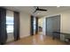 Bright bedroom with hardwood flooring, large windows, and a glimpse of the en-suite bathroom at 16902 Vinci Way, Montverde, FL 34756