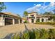 Beautifully paved driveway leading to a three-car garage, surrounded by manicured landscaping at 16902 Vinci Way, Montverde, FL 34756