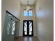 Grand foyer with soaring ceilings, modern light fixture, and decorative glass sliding door at 16902 Vinci Way, Montverde, FL 34756