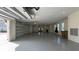 Spacious garage with epoxy floors, three garage doors, and ample lighting at 16902 Vinci Way, Montverde, FL 34756
