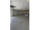 Spacious garage with epoxy flooring, multiple overhead doors, and ample storage space at 16902 Vinci Way, Montverde, FL 34756