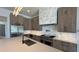Gourmet kitchen with gray cabinets, center island, and professional-grade stainless steel appliances at 16902 Vinci Way, Montverde, FL 34756