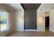 Bright living room with hardwood floors, a textured accent wall, and pendant lighting at 16902 Vinci Way, Montverde, FL 34756