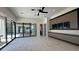Spacious living area with marble floors, modern ceiling fan, and sliding glass doors to the outdoor area at 16902 Vinci Way, Montverde, FL 34756