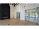 Modern living room featuring hardwood floors, herringbone fireplace, and adjacent wine room at 16902 Vinci Way, Montverde, FL 34756