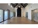 Open living room showcasing black ceiling beams, herringbone fireplace, and wine cellar at 16902 Vinci Way, Montverde, FL 34756