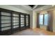 Living room with custom bookcase, hardwood floors, window with natural light, and neutral color palette at 16902 Vinci Way, Montverde, FL 34756