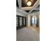 Inviting living room with ceiling detail, custom bookcase, hardwood floors, and plenty of natural light at 16902 Vinci Way, Montverde, FL 34756