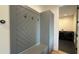 Functional mudroom with built-in storage bench, coat hooks, and cabinetry, leading into a modern laundry room at 16902 Vinci Way, Montverde, FL 34756