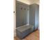Stylish gray mudroom featuring built-in bench with storage, coat hooks, and matching cabinetry with geometric paneling at 16902 Vinci Way, Montverde, FL 34756