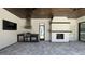 Outdoor kitchen featuring a built-in grill, fireplace, and spacious patio area at 16902 Vinci Way, Montverde, FL 34756