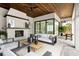 Covered patio features a fireplace, comfortable seating, and an outdoor game table at 16902 Vinci Way, Montverde, FL 34756