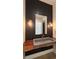 Stylish powder room featuring a unique sink on a wood counter with striking textured wallpaper at 16902 Vinci Way, Montverde, FL 34756