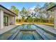 Backyard swimming pool with an elevated spa featuring mosaic tile work and private landscaping at 16902 Vinci Way, Montverde, FL 34756