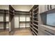 Spacious walk-in closet features custom shelving, drawers, and ample storage space, enhancing organization at 16902 Vinci Way, Montverde, FL 34756