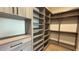 Walk-in closet with custom-built shelving and drawers designed for efficient and organized storage at 16902 Vinci Way, Montverde, FL 34756