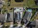 An aerial view showcasing a neighborhood with multiple homes and pools at 1809 Hawksbill Ln, St Cloud, FL 34771