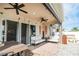 Covered patio features ceiling fans, comfortable seating, and dining table at 1809 Hawksbill Ln, St Cloud, FL 34771