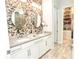 Elegant bathroom with double vanity, stone feature wall, and walk-in closet at 1809 Hawksbill Ln, St Cloud, FL 34771