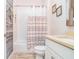 Charming bathroom with striped shower curtain and updated vanity at 1809 Hawksbill Ln, St Cloud, FL 34771