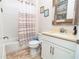 Bathroom with striped shower curtain and white vanity at 1809 Hawksbill Ln, St Cloud, FL 34771