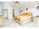 Spacious bedroom with wood-look tile flooring and a decorative wall mural at 1809 Hawksbill Ln, St Cloud, FL 34771