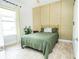 Guest bedroom with green bedding and gold metal bed frame at 1809 Hawksbill Ln, St Cloud, FL 34771