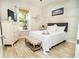 Bedroom with white dresser and wood-look floors at 1809 Hawksbill Ln, St Cloud, FL 34771